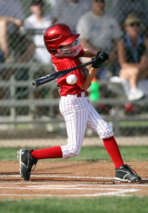 Baseball player
				hitting a big swing