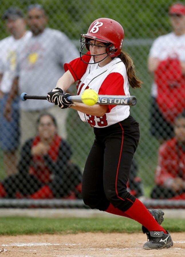 Girl baseball
				player bunting a pitch