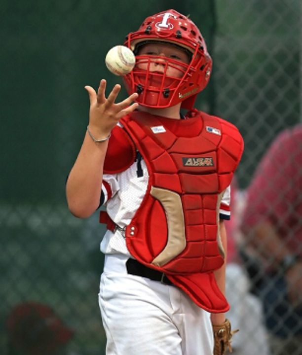 Catcher tossing ball in hand