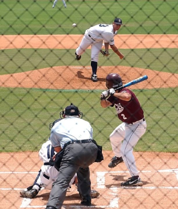 Player kicking up dust sliding into base