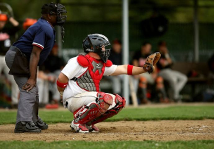 Catcher crouched on field